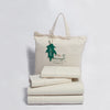GOTS-Certified Organic Cotton Flannel Sheets in front of tote bag.